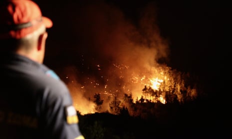 A firefighter tries to extinguish a wildfire in Asklipio village on Rhodes island.