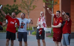 Liverpool fans make themselves heard on the street as they await their team’s coronation.