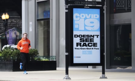 A sign warning residents of coronavirus is seen on the sidewalk in downtown Chicago.