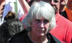 Joan Jara stands next to the coffin containing the remains of her husband during his funeral in Santiago on 5 December 2009.