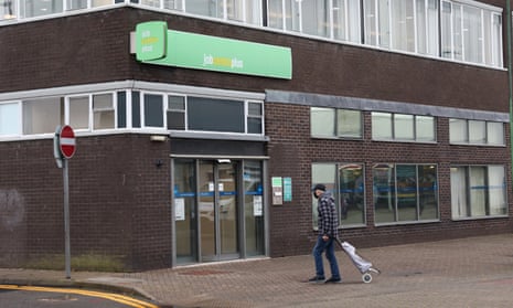 A man walks past a Jobcentre Plus employment office on November 22, 2022 in Stoke-on-Trent, England