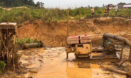 A machine in a muddy spot of dug-up soil