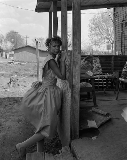 Black woman leaning against her front porch in the deep south in the 1980s