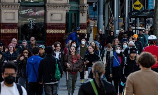People walk along Flinders Street, Melbourne