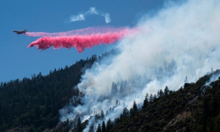 An air tanker drops fire retardant to battle the Dixie fire in Plumas county, California.