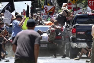 People are thrown into the air as a car drives into a group of protesters demonstrating against a white nationalist rally in Charlottesville, Virginia on 12 August, killing civil rights activist Heather Heyer