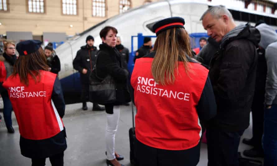 SNCF agents assist a group of commuters waiting on a platform at Marseille-Saint-Charles station.