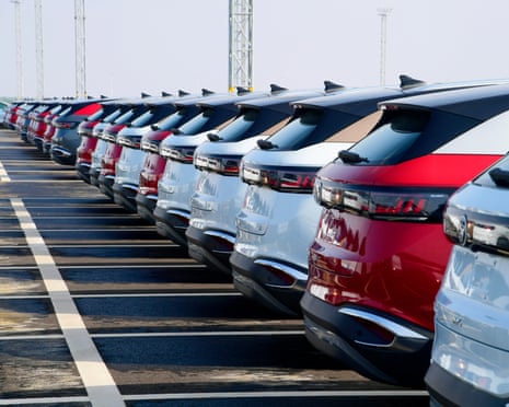 A parking lot filled with large SUVs, as far as the eye can see