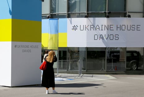 A woman stands in front of the Ukrainian House Davos, ahead of the upcoming World Economic Forum 2022, in the Alpine resort of Davos, Switzerland.