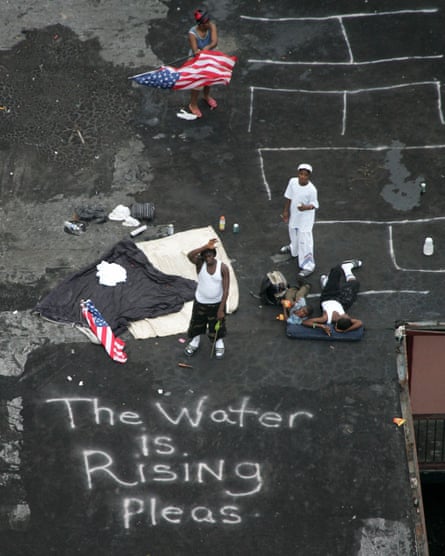 New Orleans residents wait on a rooftop to be rescued after Hurricane Katrina in 2005.