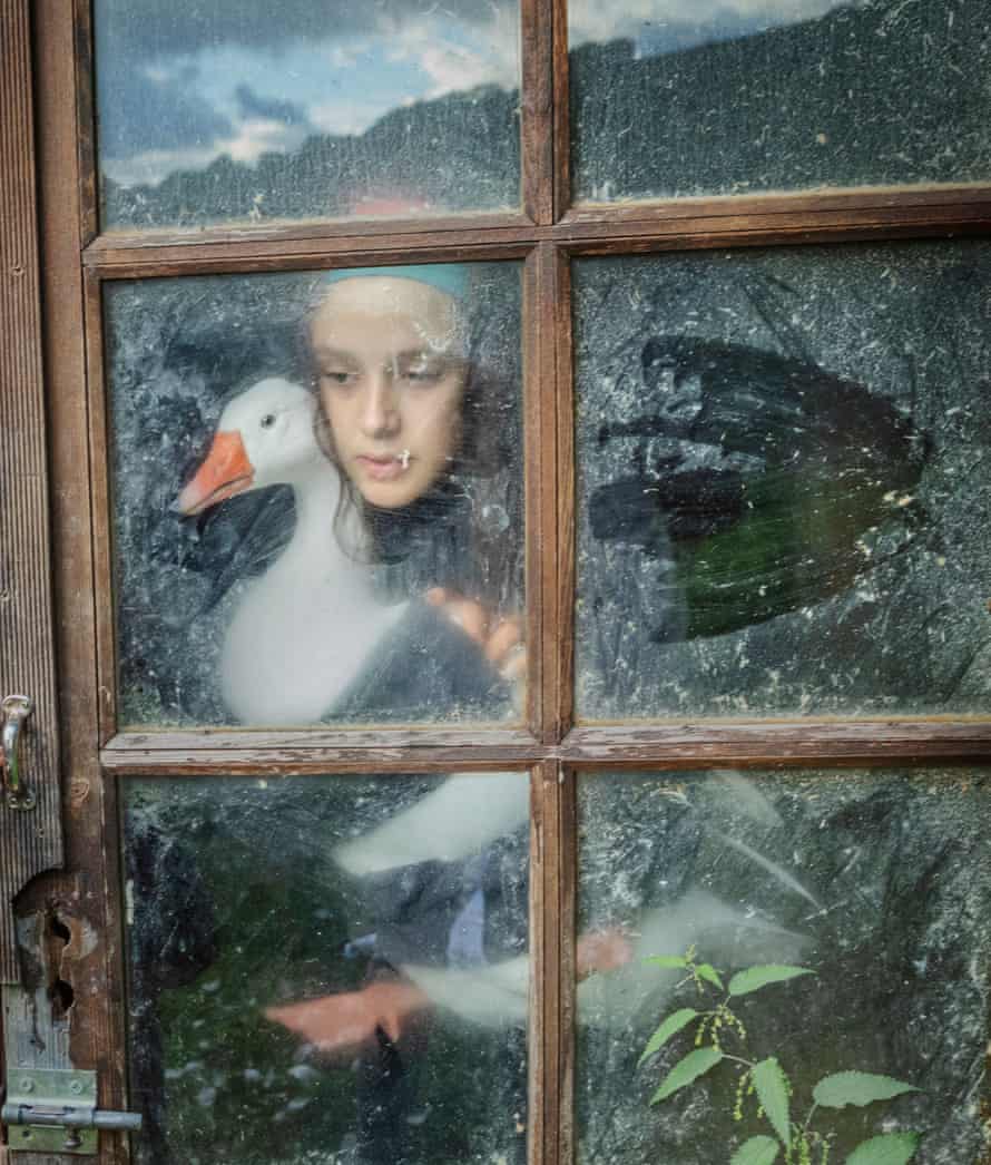 Carla Heras takes Laiteana out of the little wooden hut where the geese and ducks sleep at the Gaia sanctuary.
