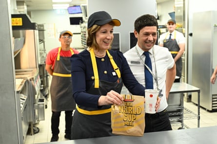 Rachel Reeves dressed in staff uniform serves a customer during a visit to a McDonald’s branch