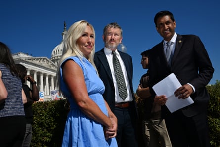 a woman and two men outside the US Capitol