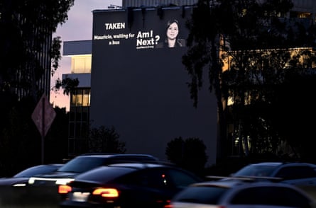 a projection on a building reads ‘am I next’
