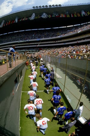 The teams take to the field of the Azteca Stadium.