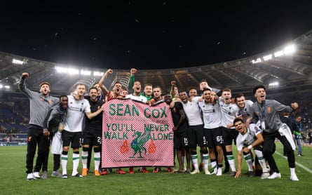 Liverpool players celebrate reaching the Champions League final with the banner for Sean Cox.
