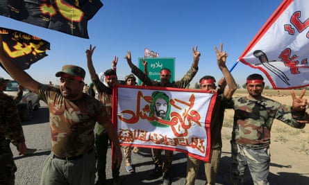Shia Popular Mobilisation Forces members celebrate on the outskirts of Kirkuk on Tuesday.