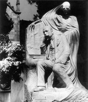 Photograph of sculpture of seated man with the figure of death behind him