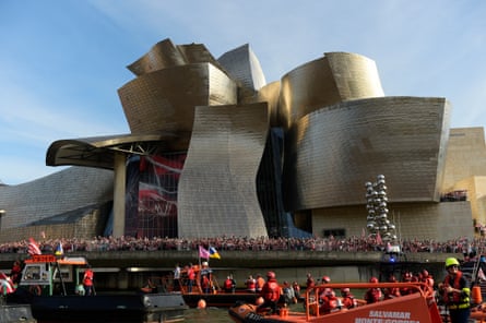 Athletic Bilbao fans wait in front of Gehry’s Guggenheim Museum on the Nervion estuary in Bilbao, Spain.