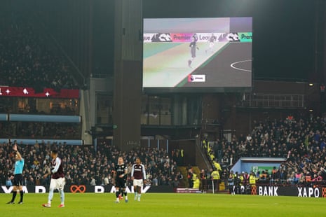 The VAR decision of offside for Aston Villa's Ollie Watkins is shown on the big screen.