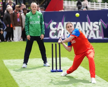 Nat Sciver-Brunt, the England cricket captain, shapes to play an aggressive shot during the captains’ carnival launch event on Waterloo Bridge for the Women’s T20 World Cup. Ireland captain Gaby Lewis stands behind her.