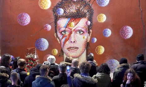 Fans gather at a mural of Bowie in Brixton after his death in January 2016.