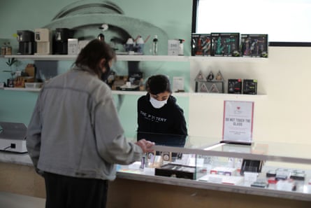 A ‘bud tender’ serves a customer at a cannabis dispensary