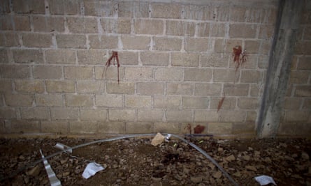 Bullet holes and blood stains in the wall of the warehouse where Mexican soldiers shot dead 22 people.