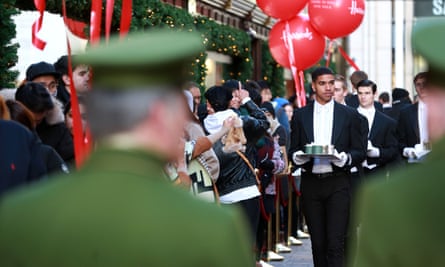Butlers serve shoppers queuing at the Harrods winter sale on Boxing Day.