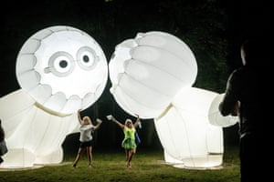 Toruń, Poland. Installation recreation artists wave to onlookers during the Bella Skyway festival