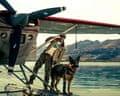 Brad Pitt and Odin the dog on a biplane in a still from the film Heart of the Beast