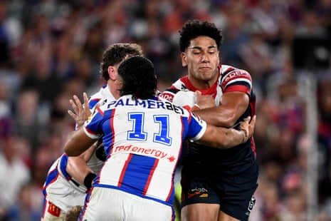 Siua Wong of the Roosters is tackled by Cody Hopwood and Jermaine McEwen of the Knights