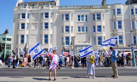 Protesters waving the Israeli flag outside the Old Ship hotel in Brighton