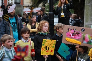 Children hold up homemade signs.