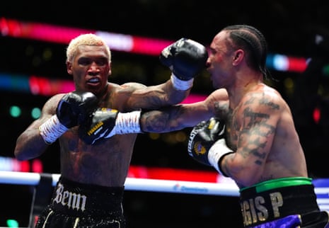 A bloody Conor Benn (left) throws punches with Regis Prograis.