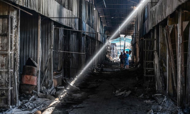 People inspect the damage caused to the central market in Sloviansk by a suspected Russian missile attack.