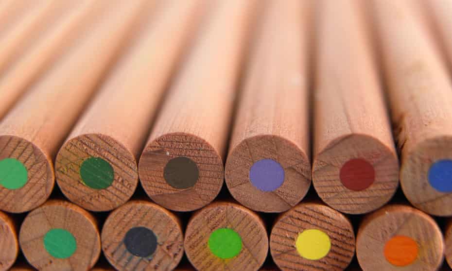 A stack of wooden coloured pencils. with the coloured centres visible at the ends