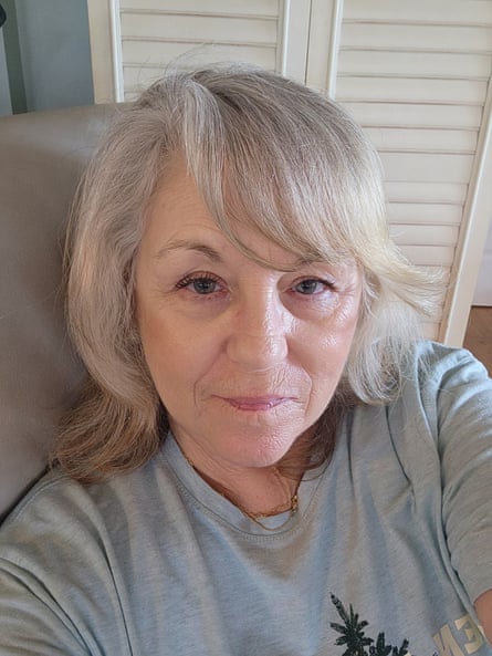 Kathryn Warren, a woman with grey hair, takes a closeup selfie looking at the camera