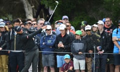 Australian golfer Adam Scott plays a shot on the first hole