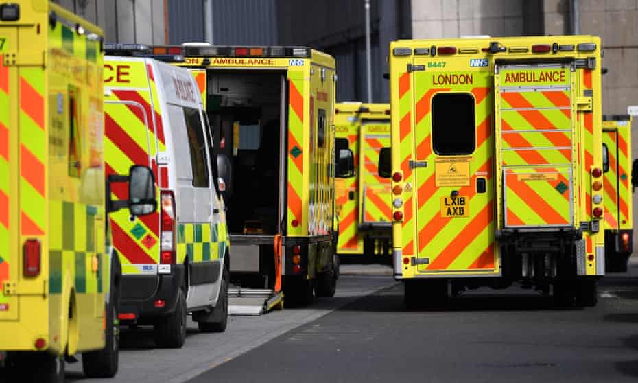 NHS ambulances wait outside the Royal London hospital in London