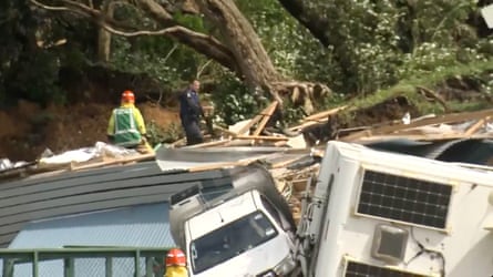Authorities search for people near the site of a landslide at the base of Mount Maunganui on New Zealand’s North Island on Thursday.