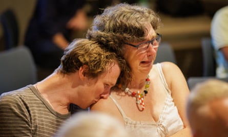 Kate Moore cries as a man leans on her shoulder