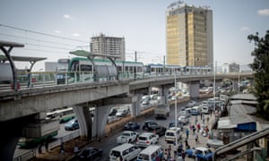 The LRT, or the light rail, runs across the busy Mexico square during rush hour.