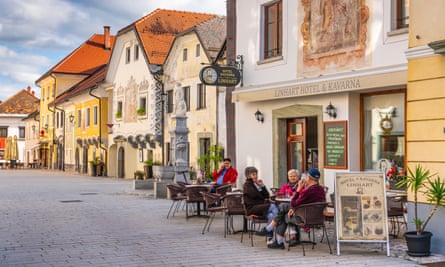 Medieval houses and people sitting outside cafe
