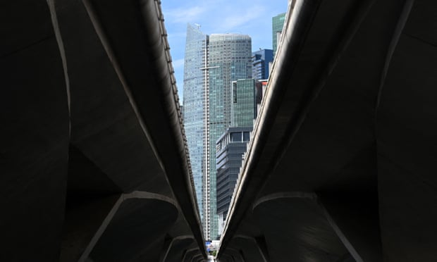A view of Singapore’s financial district between viaducts crossing a river 