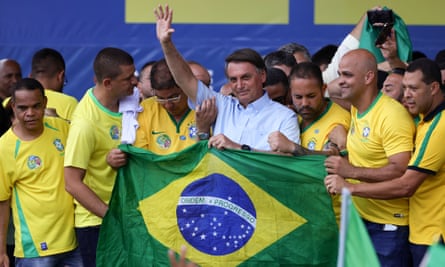 Bolsonaro surrounded by men in yellow football shirts