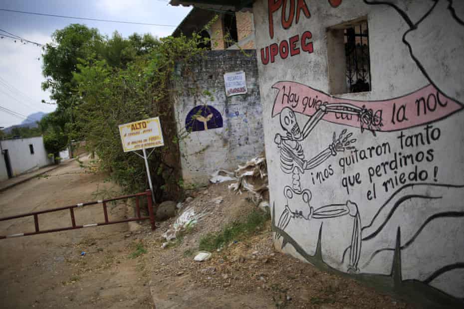 A UPOEG mural at a blocked-off town entrance in Buenavista reads: ‘They took so much from us that we lost our fear.’