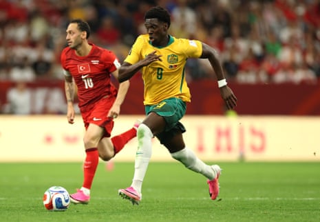 Mohamed Toure #9 of Australia runs with the ball