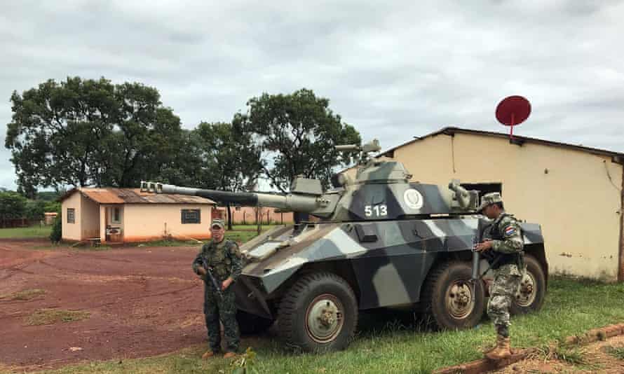 Paraguayan army soldiers are seen next to an army tank near a border prison in Pedro Juan Caballero.