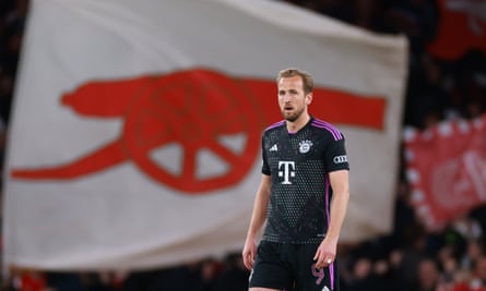 Harry Kane of Bayern Munich reacts to a backdrop of Arsenal flags after the hosts scored the opening goal
